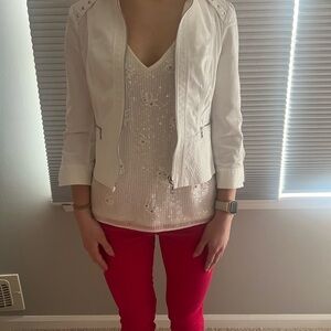 White jean jacket with laced and stitched accents on back and front